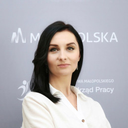 Młoda brunetka z włosami do ramion w białej eleganckiej koszuli
